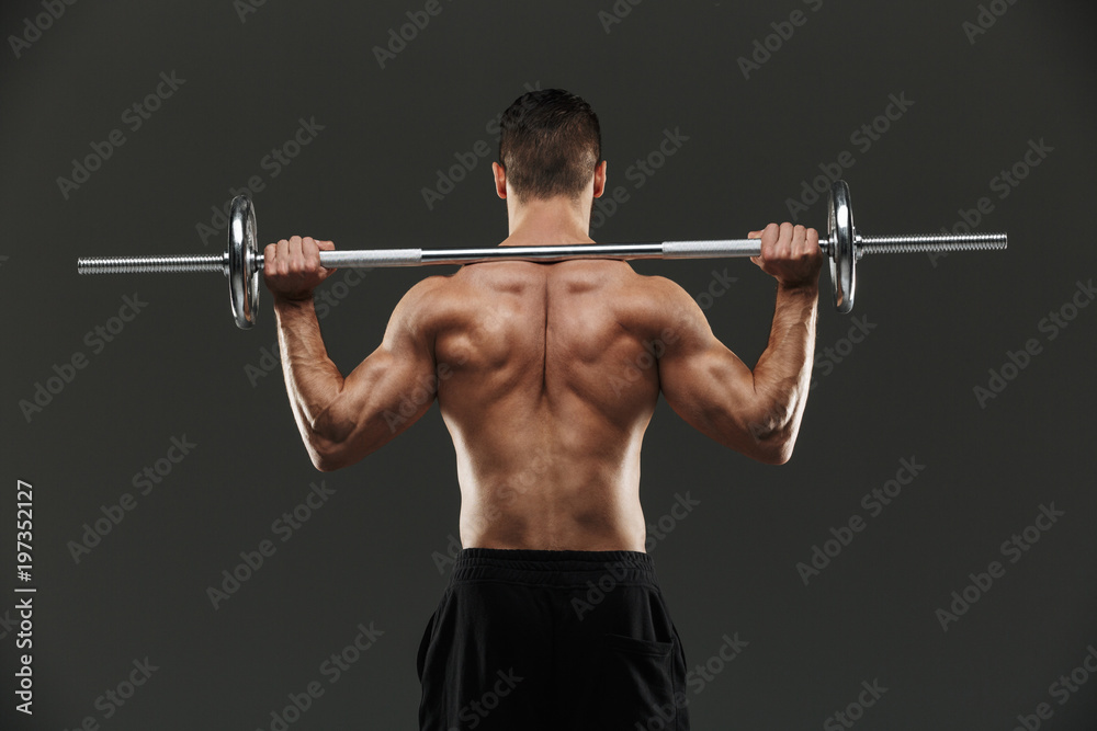 Back view portrait of a strong shirtless muscular sportsman Back view portrait of a strong shirtless muscular sportsman