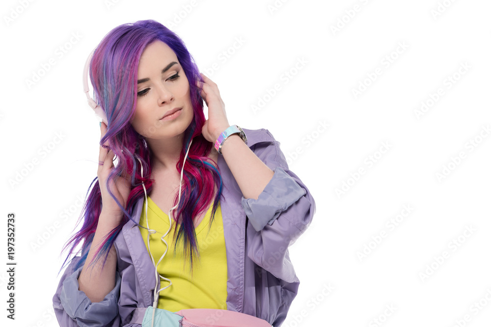 beautiful young woman with colorful hair in purple trench coat listening music with headphones isolated on white beautiful young woman with colorful hair in purple trench coat listening music with headphones isolated on white