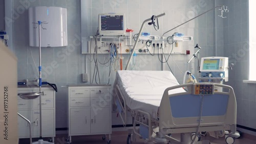 A hospital ward for one person with a bed and equipment
