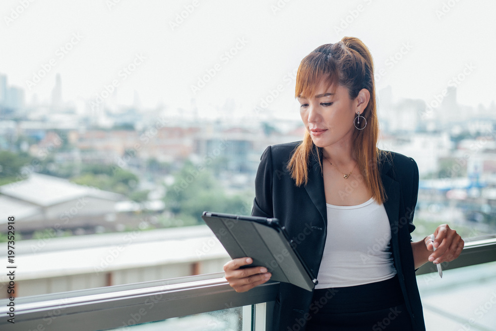 vintage style, Young business woman with tablet in the office against panoramic windows