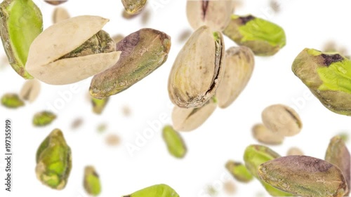 Pistachios (whole and kernels) falling down on white background (45 degrees, seamless loopable)