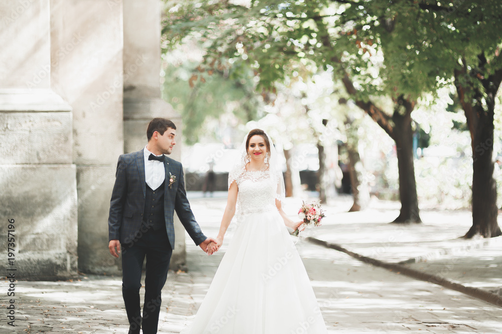 Gorgeous wedding couple walking in the old city of Lviv