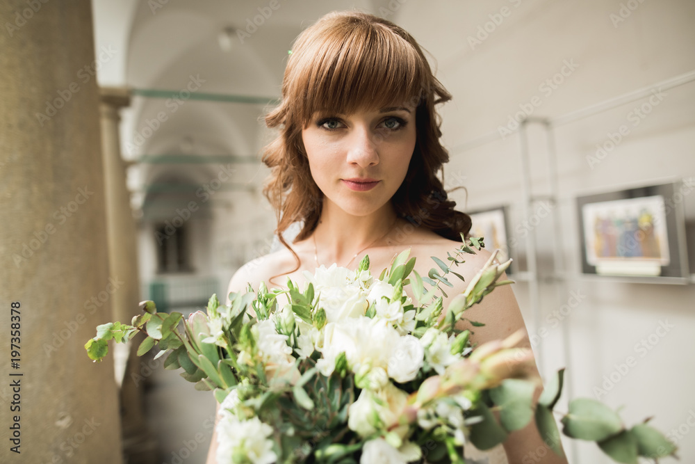 Bride holding big and beautiful wedding bouquet with flowers Bride holding big and beautiful wedding bouquet with flowers