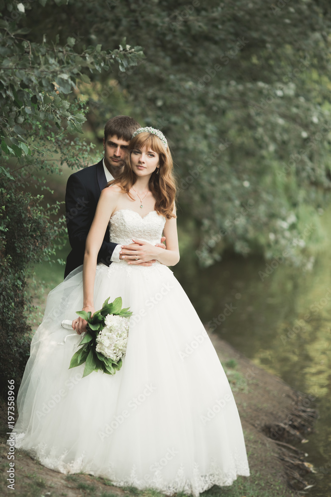 Happy wedding couple walking in a botanical park Happy wedding couple walking in a botanical park