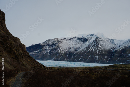 A glacier in Iceland between some mountains photo