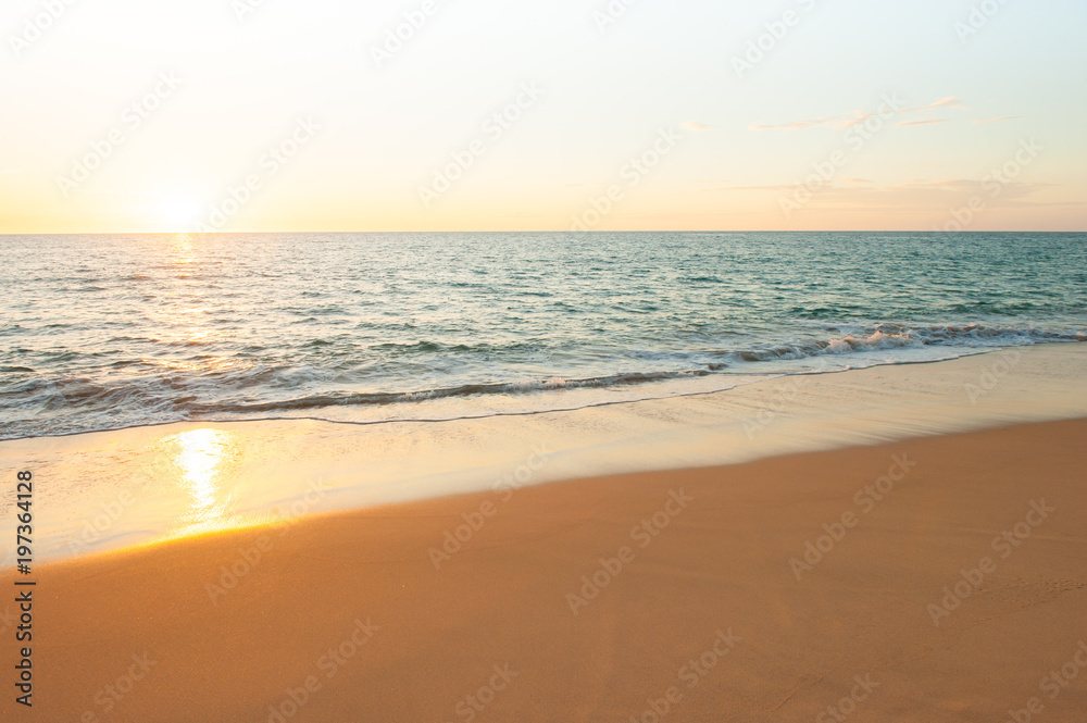 A tranquil tropical beach at sunset.