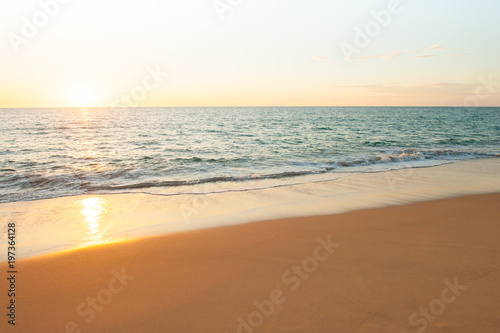 A tranquil tropical beach at sunset.