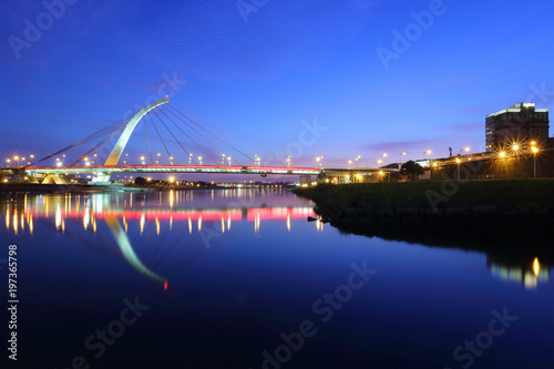 The famous cable-stayed Dazhi Bridge spanning over Keelung River at dusk in Taipei City Taiwan, Asia ~ A romantic landmark bridge of Taipei with beautiful reflections on smooth water under evening sky