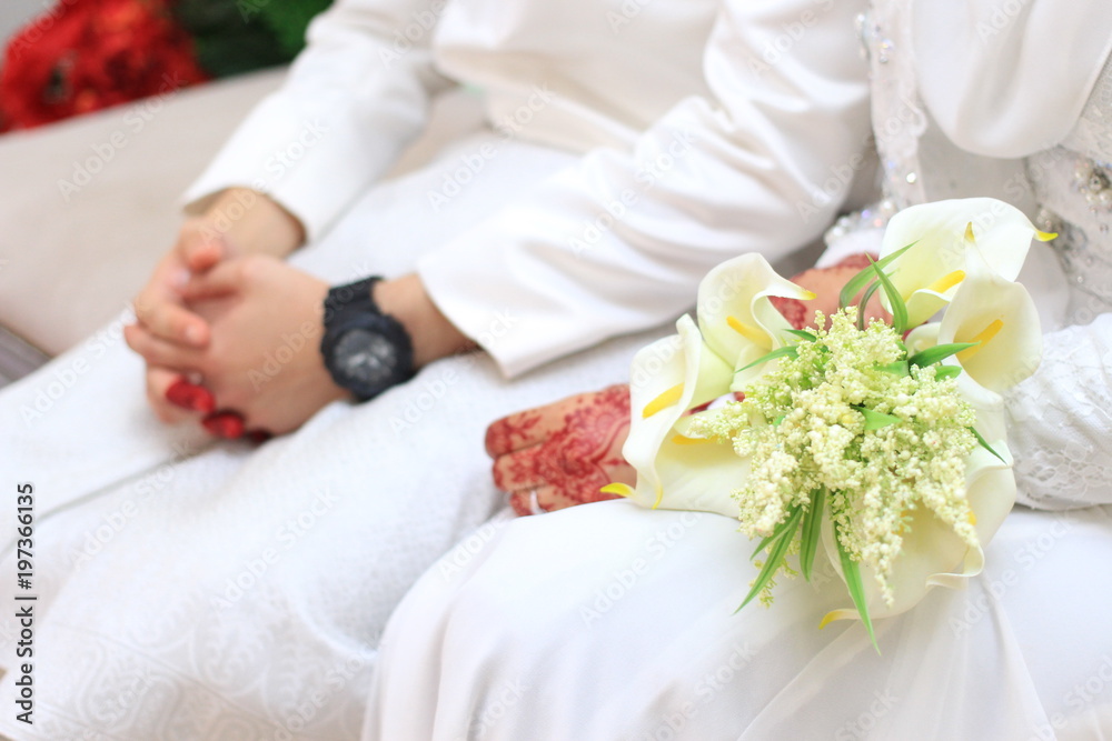 Brides hand with bouquet flower Brides hand with bouquet flower