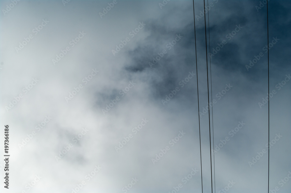 Wires and the cloudy sky