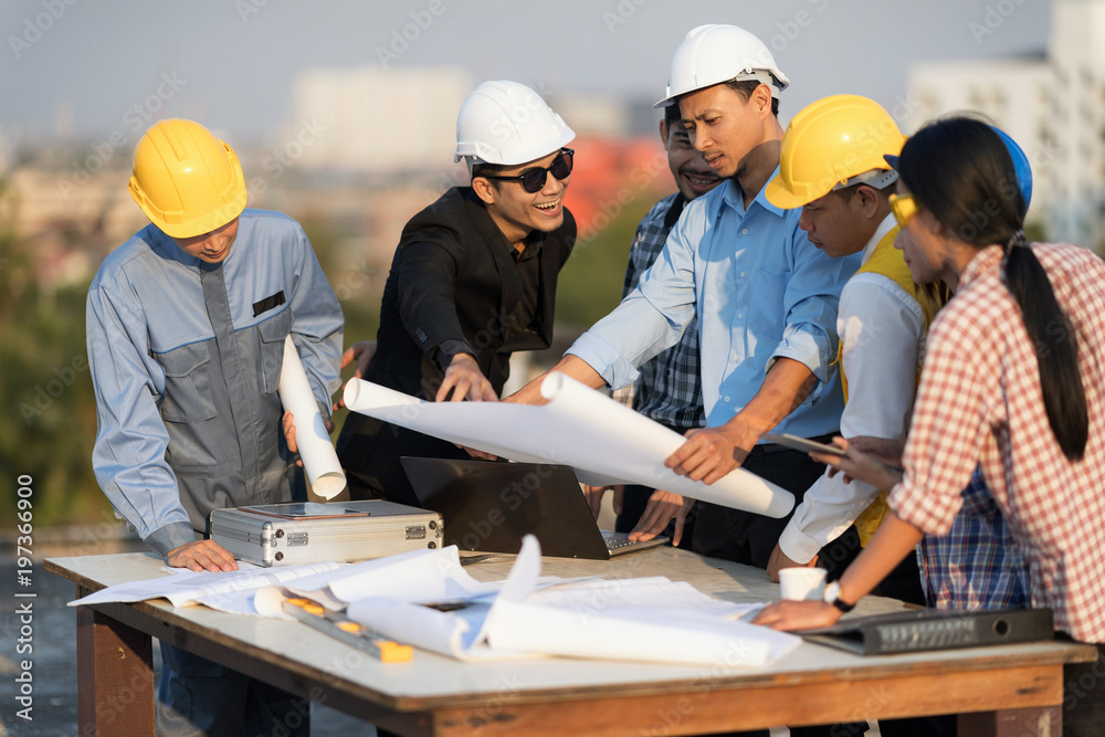 Businessman working with Architect Engineer on the rooftop building Construction Site with blueprint. Businessman working with Architect Engineer on the rooftop building Construction Site with blueprint.