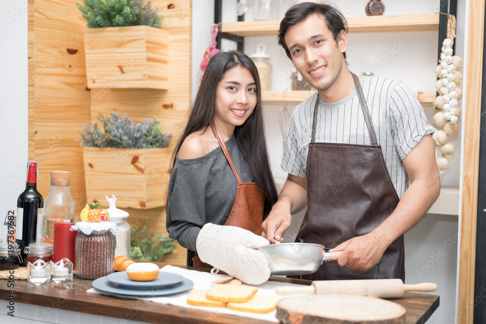 lover couple bake bread for dinner party tonight. lover couple bake bread for dinner party tonight.