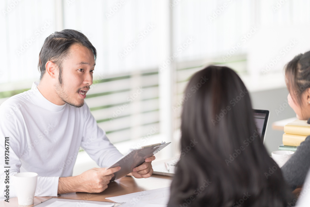 Business people have a meeting with presentation in office, they negotiate a contract.New project interview concept.Businessman explaining and listen to parnership answers.