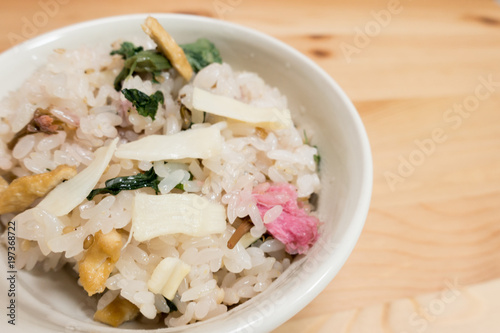 Japanese food, okawa (sticky rice) with vegetables and sakura flower.