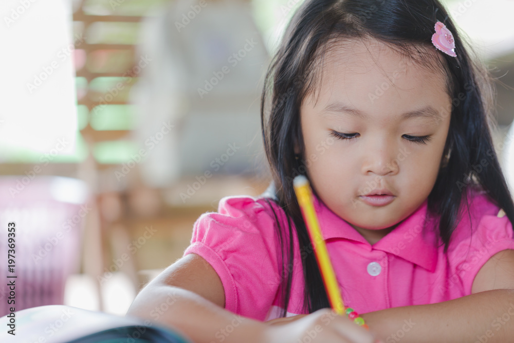 Little asian kid at home doing homework Little asian kid at home doing homework