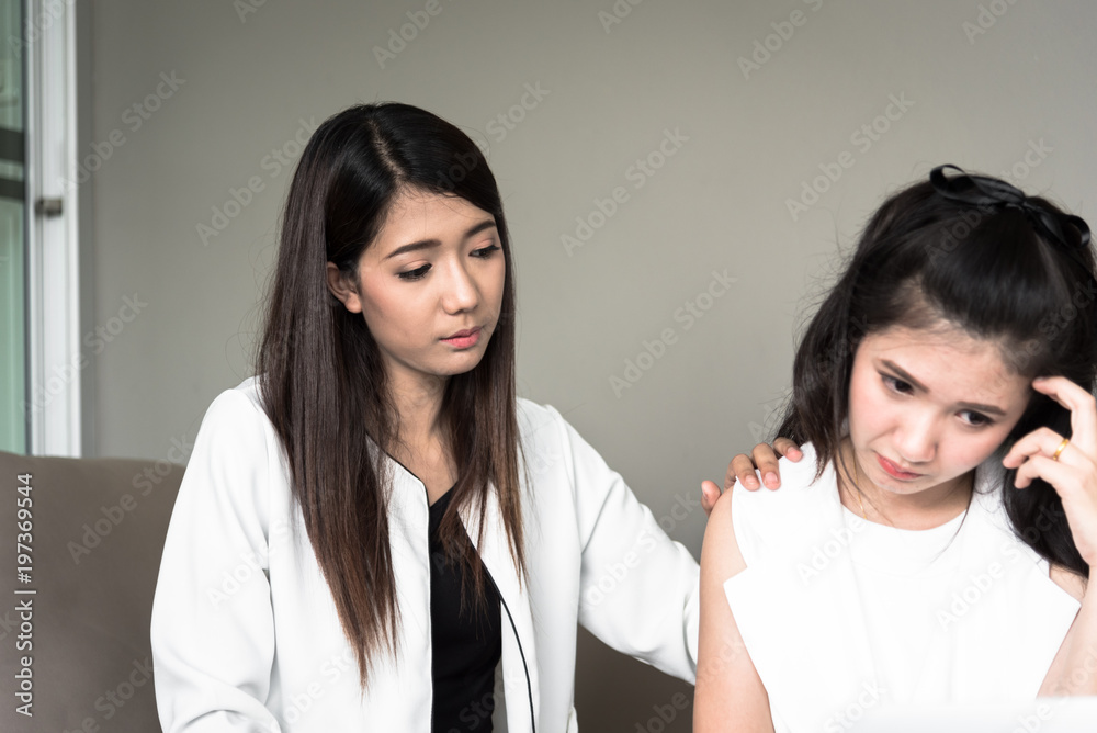 Businesswoman manager has teaching and helping to work for new employee with intention and seriously in the office interior.