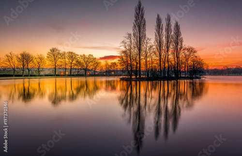 Pontefract Park Lake and reflection on water at sunrise, West Yorkshire, UK