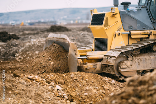 highway construction site close up with industrial machinery, excavator and bulldozer working
