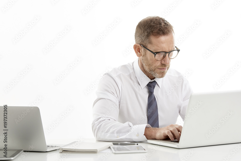 Businessman using laptops while working against white isolated background. Businessman using laptops while working against white isolated background.