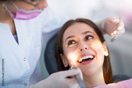 Dentist and patient in dentist office 