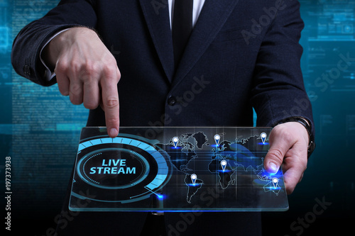 Business, Technology, Internet and network concept. Young businessman working on a virtual screen of the future and sees the inscription: Live stream