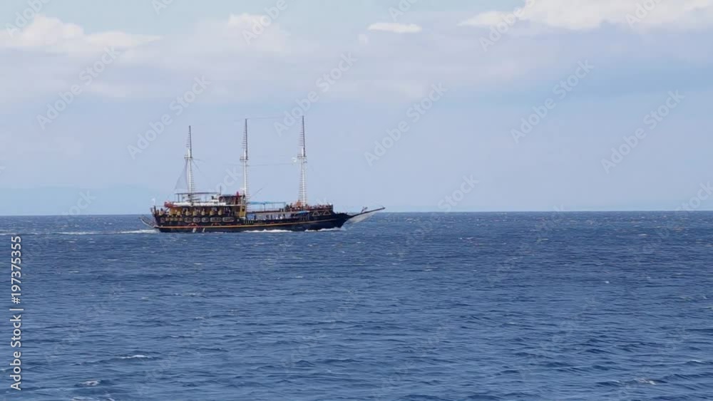 A tourist boat cruises the sea A tourist boat cruises the sea