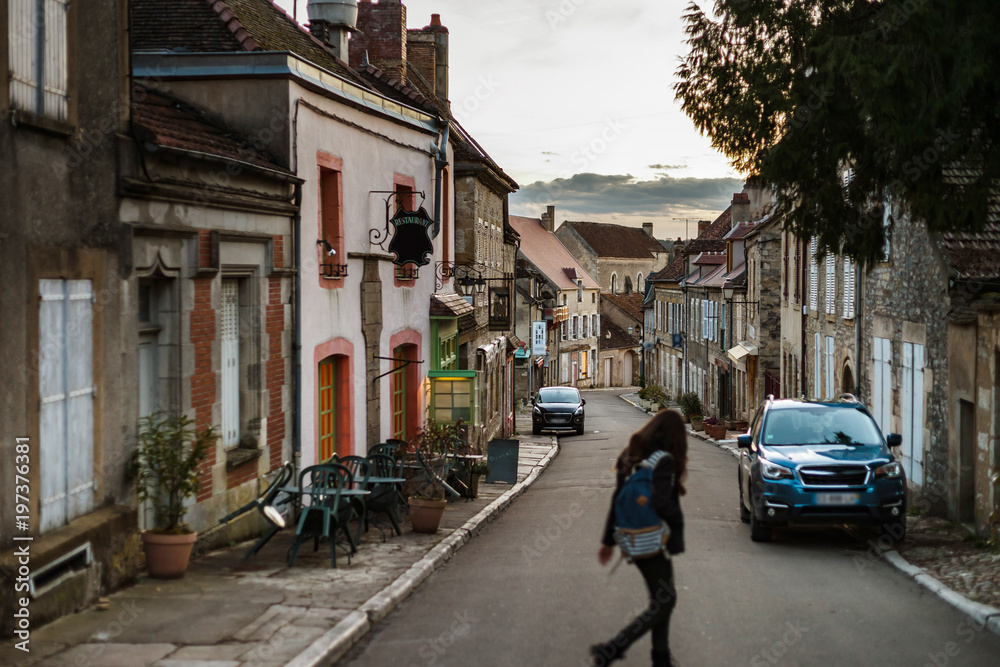 Narrow street in old french city Vezelay, evening time