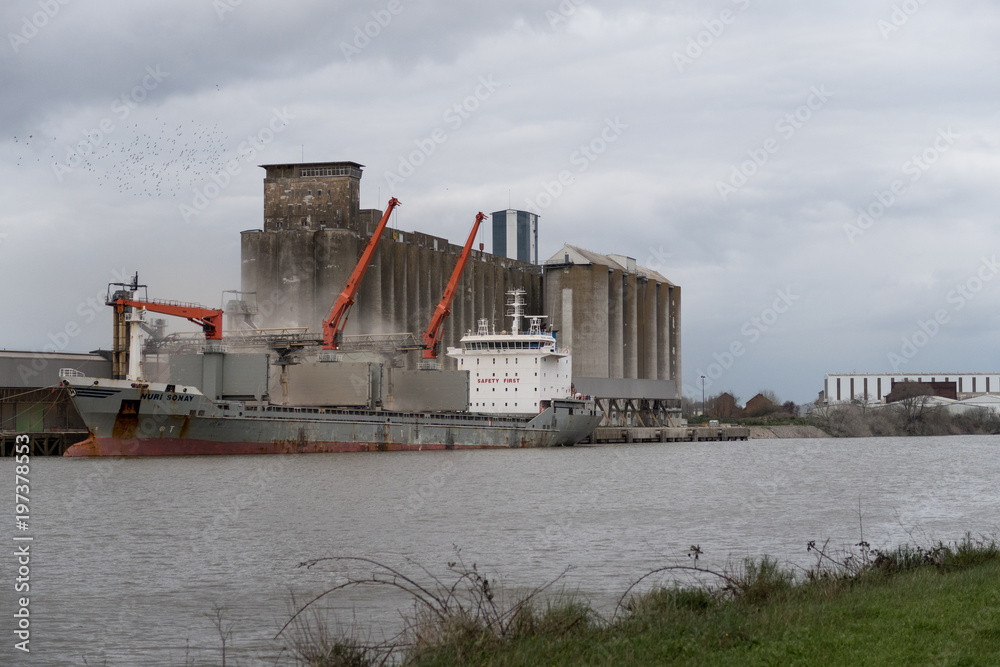 Industrial port with grain elevator and ships Industrial port with grain elevator and ships