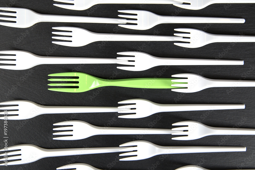 Plastic fork white and a green in between