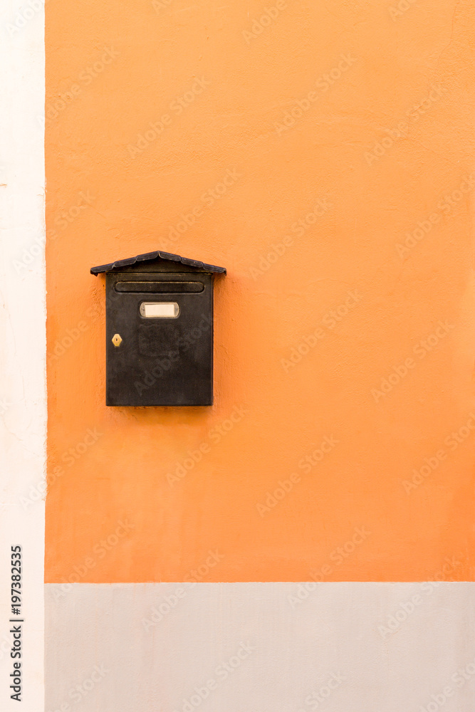 Old brown mail box on colorful wall Old brown mail box on colorful wall