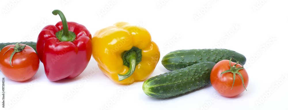 Red pepper with yellow pepper and tomatoes on a white background. Cucumbers with peppers and tomatoes.