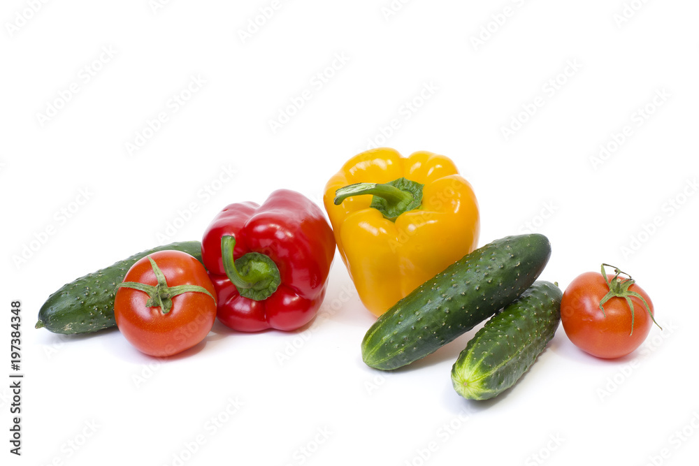 Red pepper with yellow pepper and tomatoes on a white background. Cucumbers with peppers and tomatoes. Red pepper with yellow pepper and tomatoes on a white background. Cucumbers with peppers and tomatoes.
