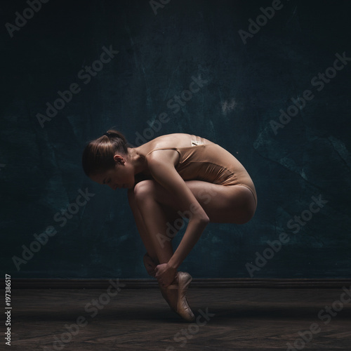 young beautiful ballet dancer in beige swimsuit