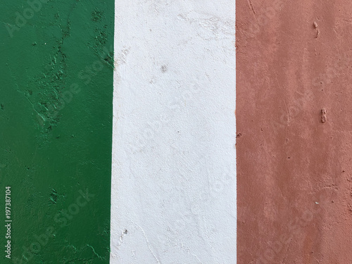 Italian flag, green red white, painted with paint on a concrete wall, emblem of the Italian state, symbol of patriotism and belonging to the republic, texture, background, travel, sport, Milan, Italy © Angela