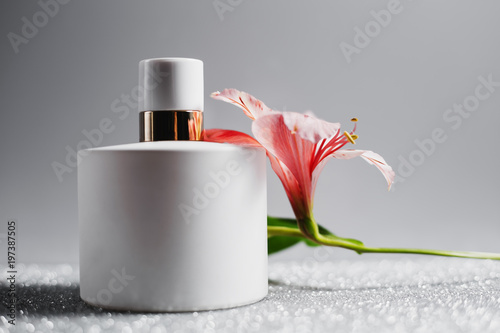 perfume spray bottle with pink flowers photo