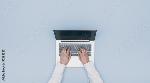 Hands typing on a laptop photo