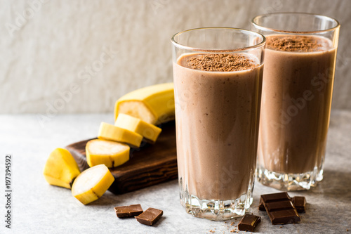 Konstfotografi Chocolate banana smoothie in glass on gray stone background