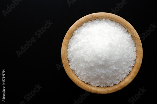 sea salt in wooden bowl isolated on black