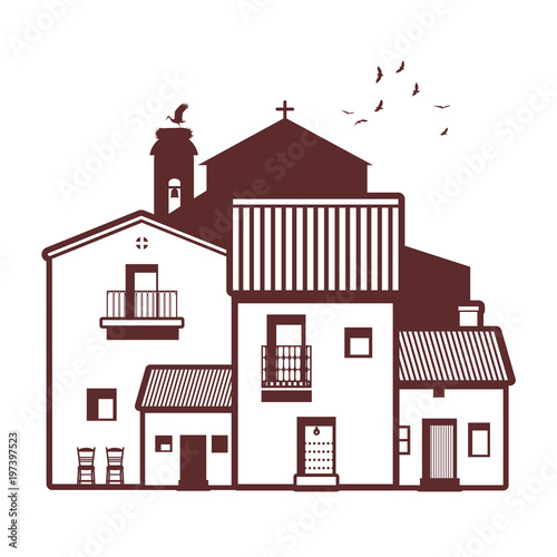 Typical Spanish village, bell tower, stork and birds on the sky in the background