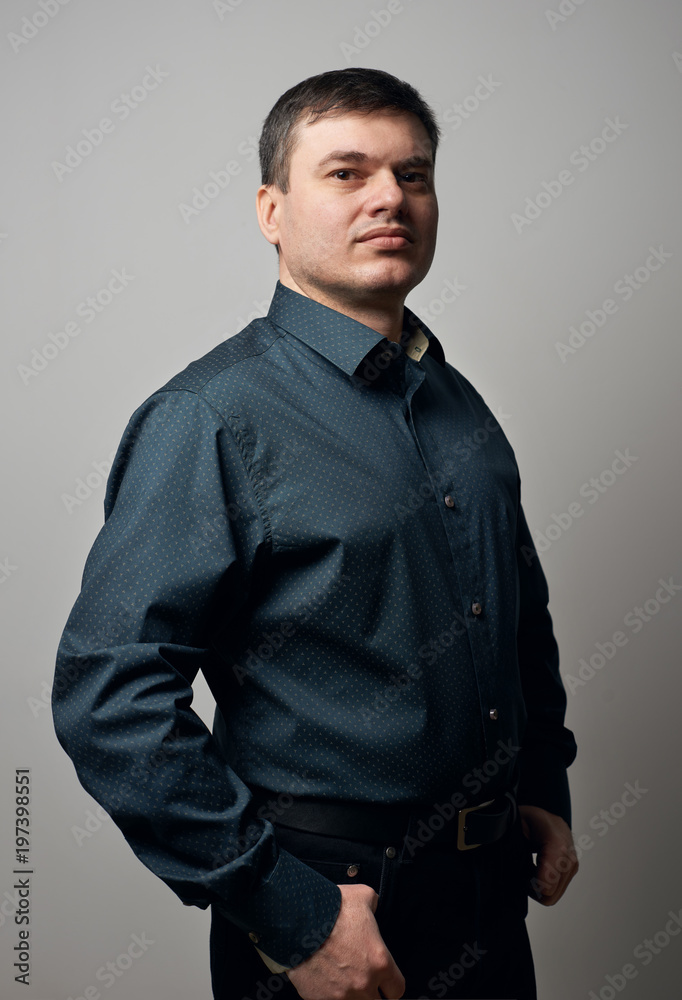 Fototapeta premium man portrait dressed in shirt and black pants over gray background