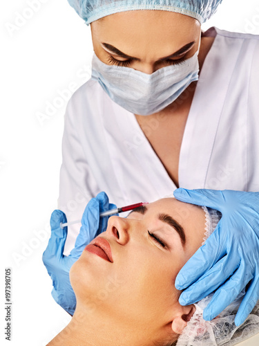 Filler injection for female forehead face. Plastic aesthetic facial surgery by doctor in beauty clinic. Beauty woman giving njections. Doctor in medical gloves with syringe. Acne Removal.