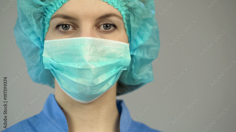 Woman doctor in protective mask blue uniform, first medical aid, occupation Woman doctor in protective mask blue uniform, first medical aid, occupation