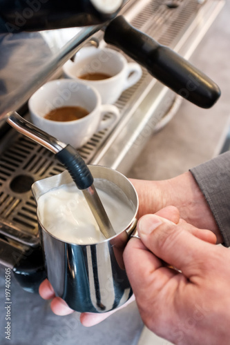Steaming and frothing milk in tumbler for cappuccino or latte