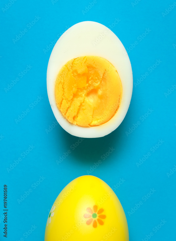 Boiled eggs cut in half on colorful background.
Boiled eggs cut in half on colorful background.