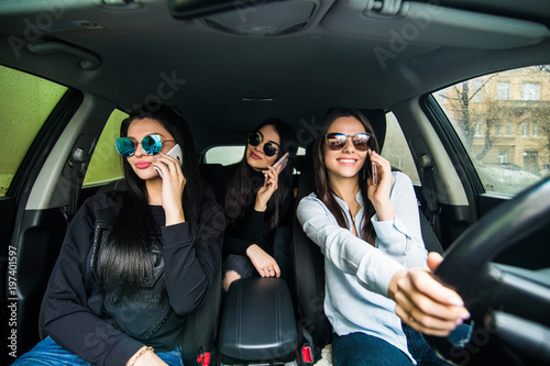 Three young women friends talking in the o car speak on phone © F8  \ Suport Ukraine
