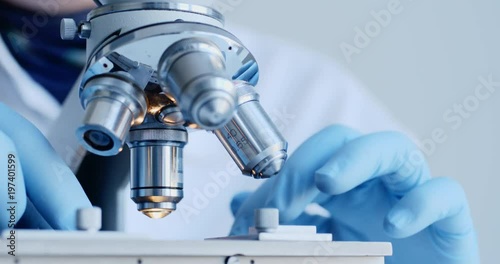 Scientist hands with microscope close-up shot in the laboratory