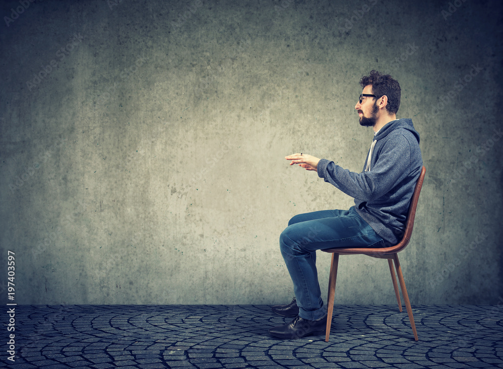 Man sitting at imaginary table Man sitting at imaginary table