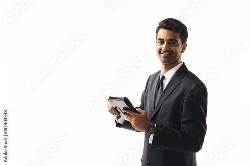Portrait of a man in business suit holding an electronic writing pad, isolated on white background