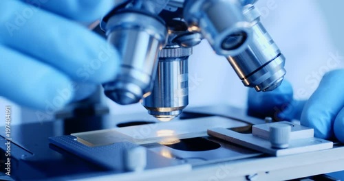 Scientist hands with microscope close-up shot in the laboratory photo