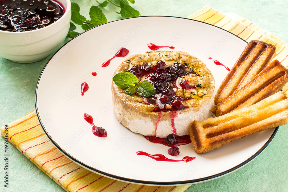 Baked brie cheese with cowberry sauce Baked brie cheese with cowberry sauce